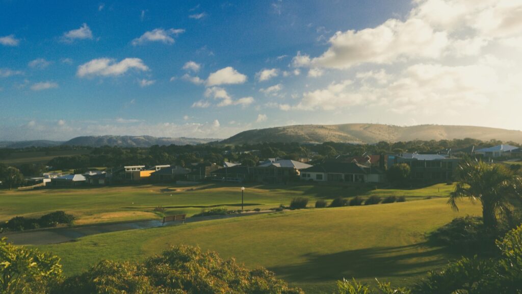 This stunning Aussie landscape features a sun - kissed golf course with rolling greens, surrounded by charming homes and framed by distant hills under a bright blue sky with scattered clouds. For a different kind of digital adventure, explore "Byte The App That Once Tried to Dethrone TikTok" and see how it aimed to shake up the social media scene.